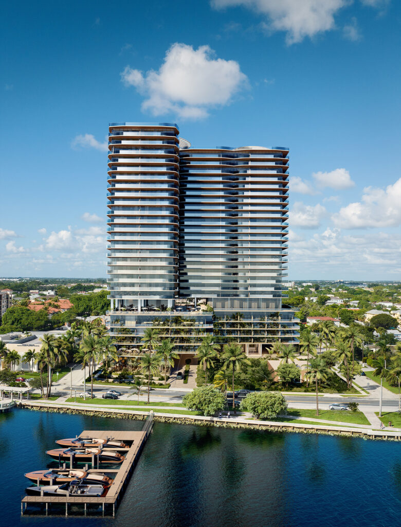 Twin modern waterfront residential towers with curved glass balconies rising above palm trees and a private marina with docked boats.