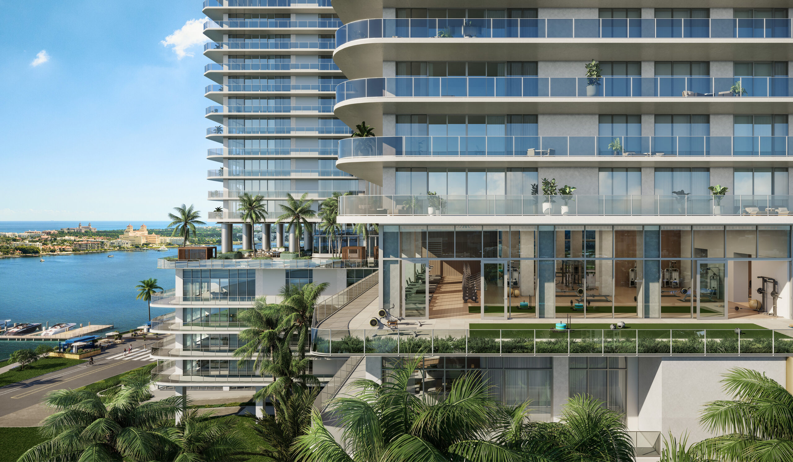 Modern waterfront condominium tower with curved glass balconies and a glass-walled fitness center overlooking the marina and ocean.